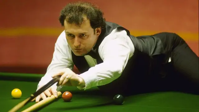 Jimmy White plays a shot with the rest at the 1994 World Championship