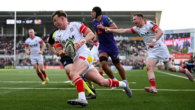 Jack Murphy runs over with the ball in his hand to score a try