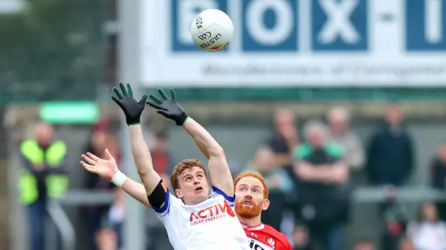 Conor Glass and Karl Gallagher compete for the ball