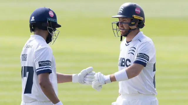 Zafar Gohar and Ryan Higgins bump fists