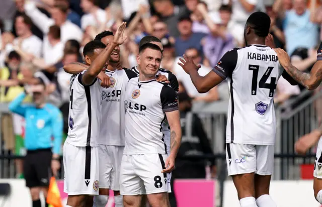 Bromley players celebrate taking the lead against Walsall