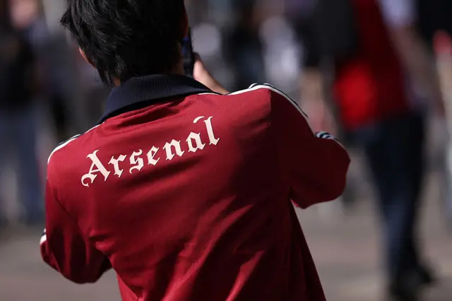 Man in jacket with Arsenal on the back