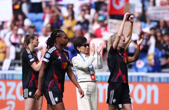 Kang celebrates with Lyon players on the pitch