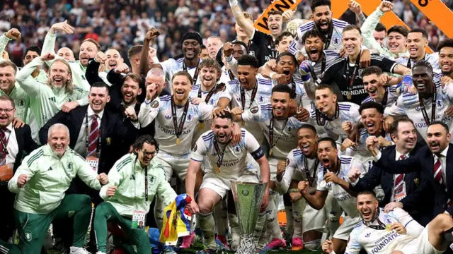 Players of Aston Villa pose for a photo with the UEFA Europa League trophy
