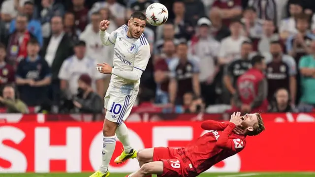 Jan-Niklas Beste of Sport-Club Freiburg s fouled by Emi Buendia of Aston Villa