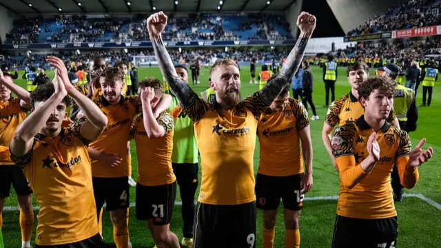 Hull City Football team celebrating a win on the pitch