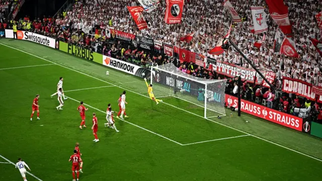 Noah Atubolu of Sport-Club Freiburg fails to save Aston Villa's second goal, scored by Emi Buendia