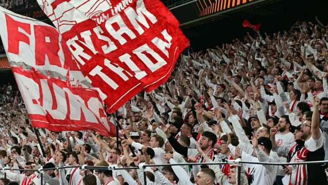 SC Freiburg supporters cheer their team on from the stands ahead of the UEFA Europa League final football match between SC Freiburg and Aston Villa