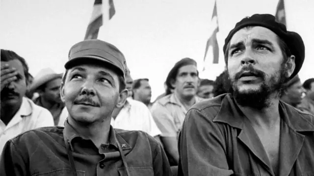 A 1964 photograph showing Raúl Castro (left), sitting besides Che Guevara (right)