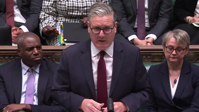 Keir Starmer speaks during PMQs. He is flanked by David Lammy and Yvette Cooper