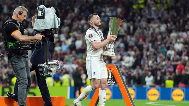 John McGinn of Aston Villa holds the UEFA Europa League trophy