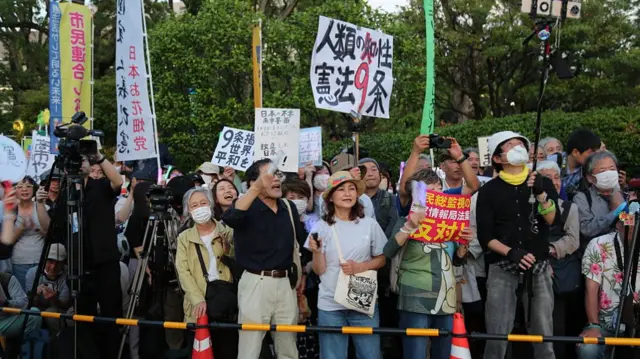 A crowd holding signs