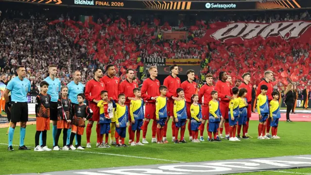 The match officials and players of Sport-Club Freiburg line up prior to kick-off ahead of the UEFA Europa League Final