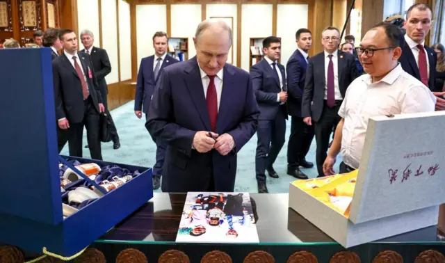 Russian President Vladimir Putin meets with Chinese engineer Peng Pai, who was photographed with him as a child 25 years ago during his first visit to China, at the Great Hall of the People in Beijing, China May 20, 2026.