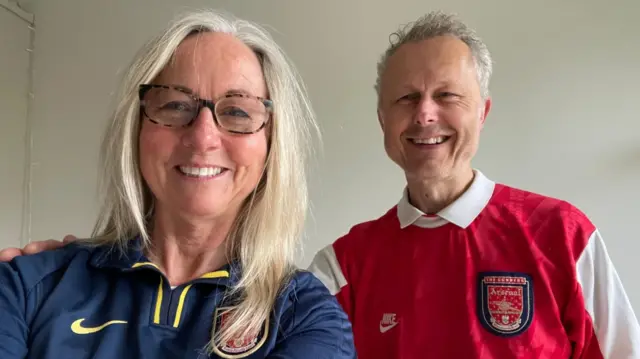 Mark and his wife in Arsenal kits