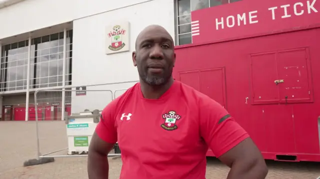 A man wearing a red Southampotn football club top stood outside the St Mary's stadium