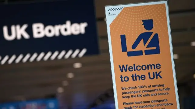 A sign at UK border control reading "Welcome to the UK"