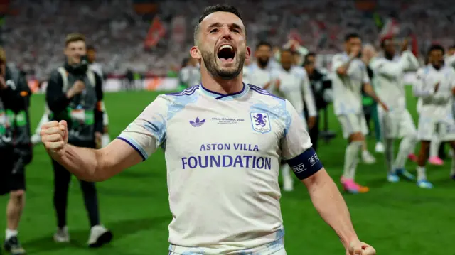 John McGinn puffs his chest out and yells on the pitch