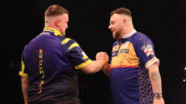 Luke Littler and Josh Rock shake hands after their match during night sixteen of the 2026 BetMGM Premier League at the Utilita Arena, Sheffield