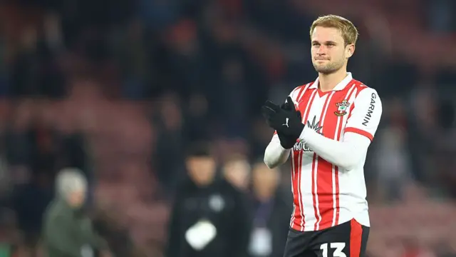 Leo Scienza of Southampton, wearing his kit and applauding while on the pitch.