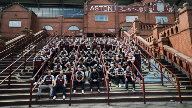 The Aston Villa team gathered on the steps outside Villa Park.