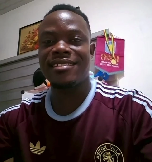 Owusu Boakye Amando wearing an Aston Villa top