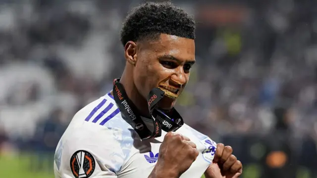 Ollie Watkins of Aston Villa celebrates biting the medal