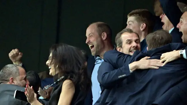 Prince William celebrates with his fist in the air as Villa win