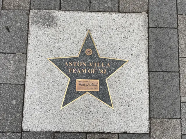 A star on Broad Street. It reads: 'Aston Villa team of 82'