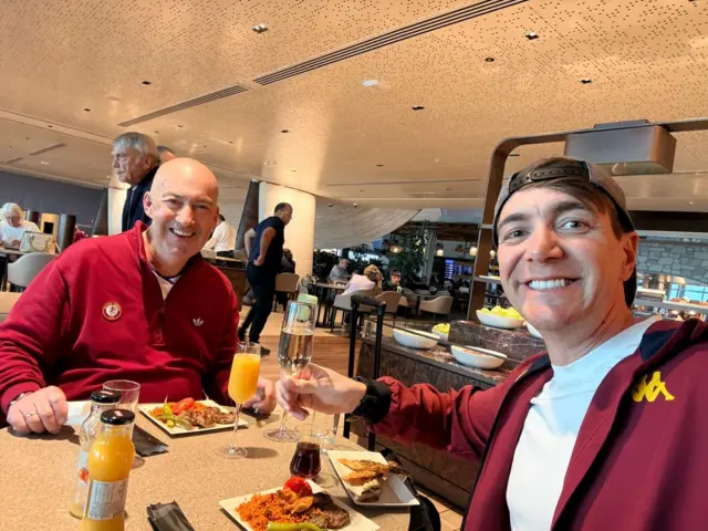 Nigel Waldron and Oliver Phelps in Villa tops are eating a fried breakfast