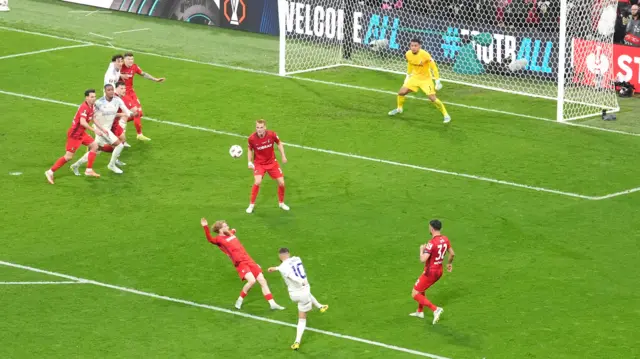 Emi Buendia shoots. A few defenders in red stand between him and the goal