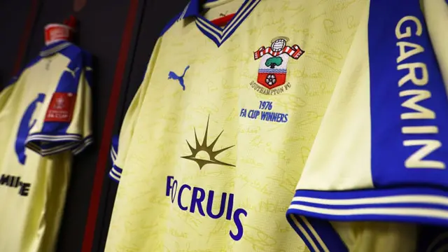 A close-up of a Southampton football club shirt with P&O Cruises branding, a Puma logo and a Garmin logo