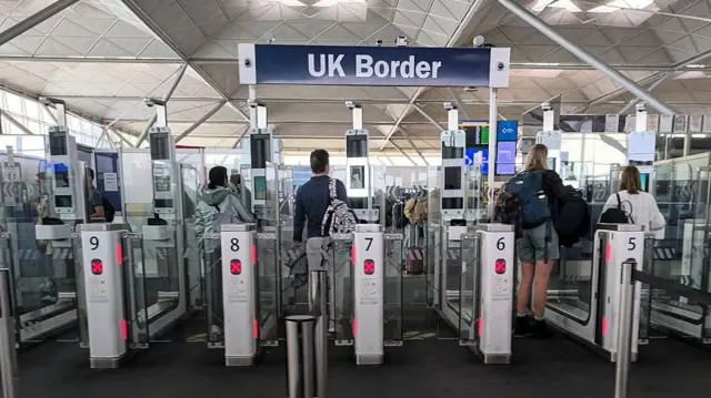 UK Border and passport control sign seen at the arrivals hall and visa area with the automated biometric passport control.