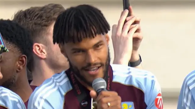 Tyrone Mings speaks into a microphone during the Aston Villa parade.