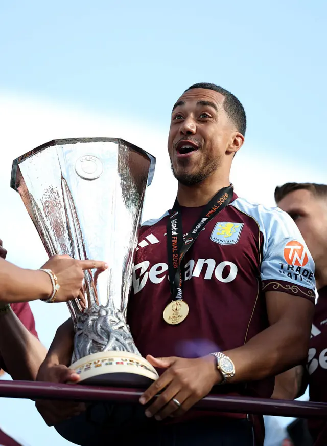 Ezri Konsa of Aston Villa poses for a photo with the Europa League Trophy