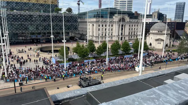 A picture from a rooftop showing a crowd of Aston Villa fans gathered below as they await the start of the cup parade in Birmingham