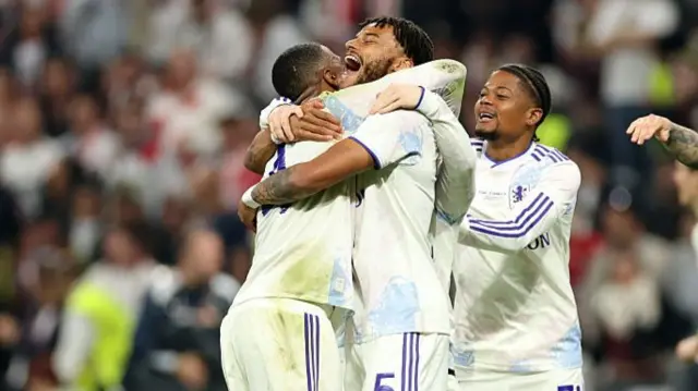 Ezri Konsa and Tyrone Mings hug eachother