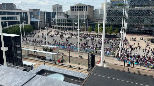 A picture from a rooftop showing a crowd of Aston Villa fans gathered below as they await the start of the cup parade in Birmingham
