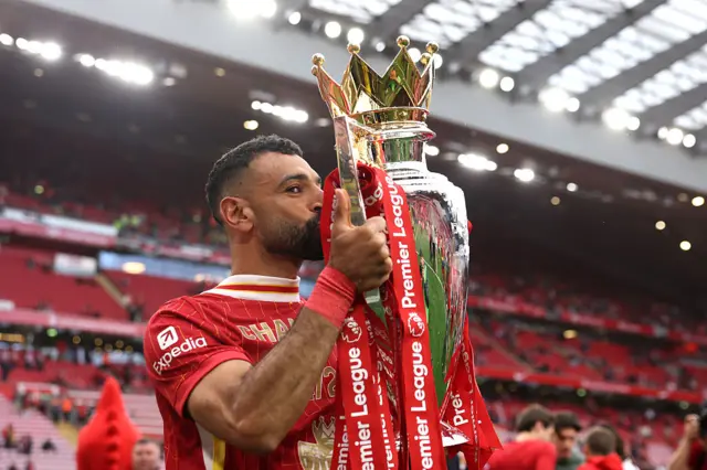 Mohamed Salah of Liverpool kisses the Premier League trophy
