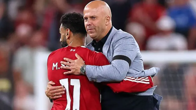 Arne Slot manager / head coach of Liverpool hugs Mohamed Salah of Liverpoo