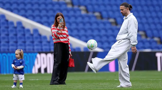 Jack Grealish playing football with his daughter at the Hill Dickinson Stadium after their final match against Sunderland