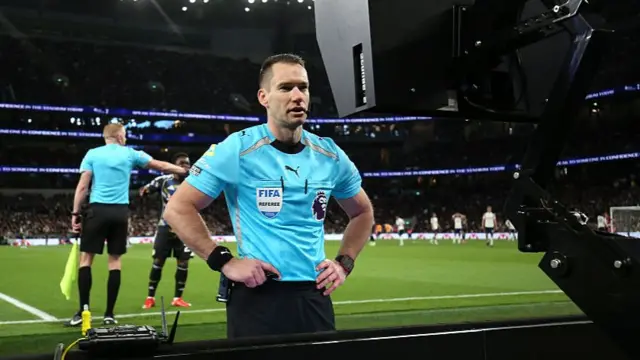 Jared Gillett consults a sideline monitor during a VAR check for a Leeds penalty against Tottenham in the Premier League earlier this month