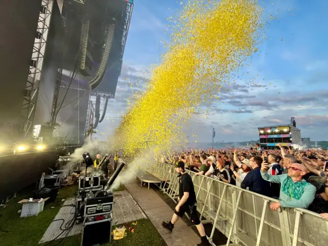 Yellow confetti exploding out of a canon