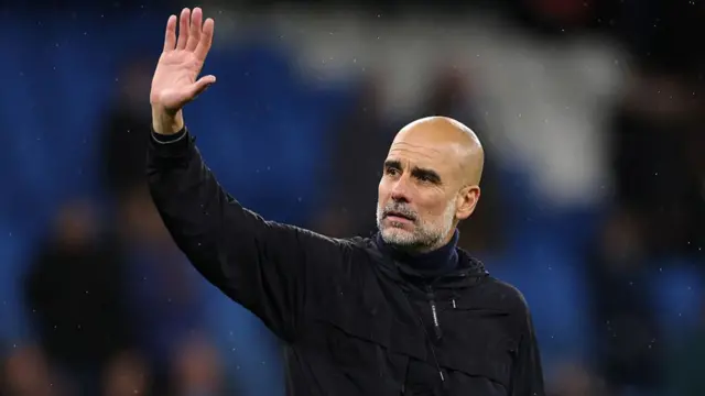 Pep Guardiola, Manager of Manchester City, waves to the crowd