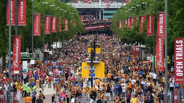 Fans walk along Wembley Way outside the stadium