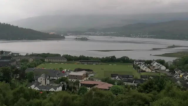 A small town by the side of a loch in grey weather