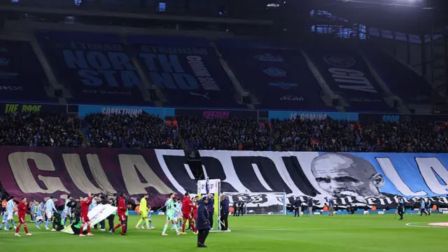 : Fans of Manchester City celebrate Pep Guardiola Manager / Head Coach of Manchester City's 1000th game in management as both teams walk out