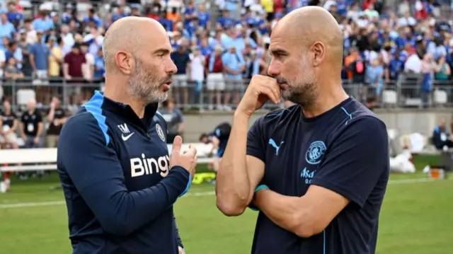 Enzo Maresca, Manager of Chelsea talks to Pep Guardiola, Manager of Manchester City