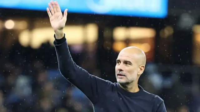 Manchester City manager Pep Guardiola waves to the fans on the final whistle