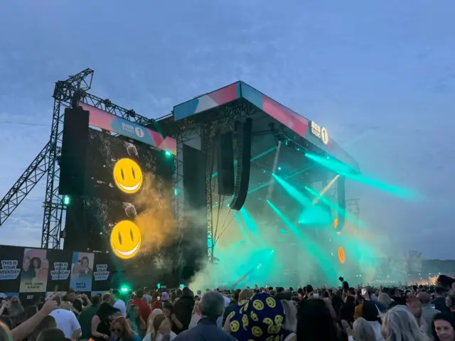 Turquoise lasers pointing out of the Main Stage at Big Weekend
